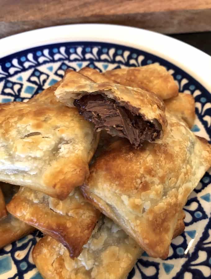 Nutella pastry puffs on pretty blue plate.