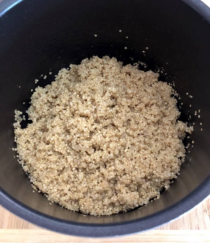 Cooked quinoa that's been fluffed in pot.