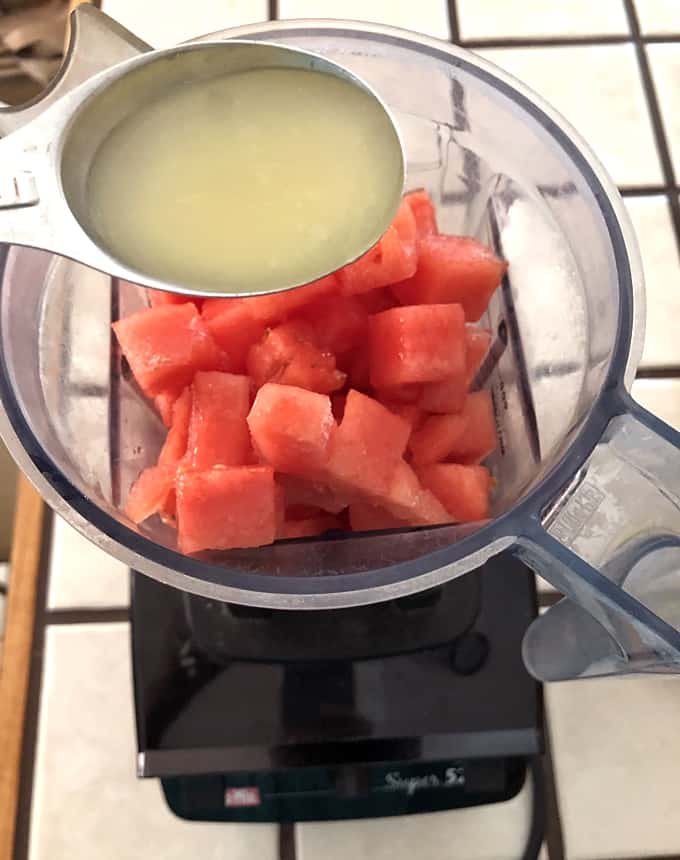 Vitamix blender with frozen cubed watermelon and lime juice