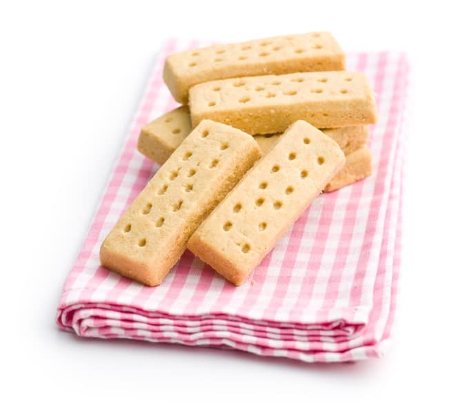 Shortbread finger cookies on pink checkered napkin.