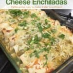 Turkey spinach goat cheese enchiladas verdes in glass baking dish garnished with chopped green onions and cilantro.