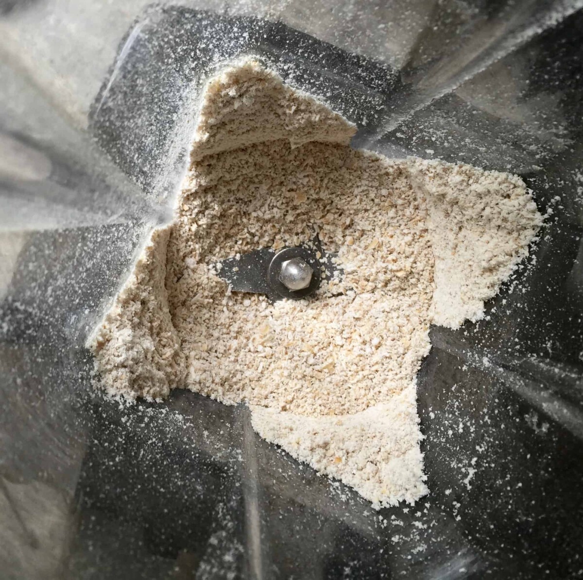 Making oat flour from old-fashioned oats in high-powered Vitamix blender.
