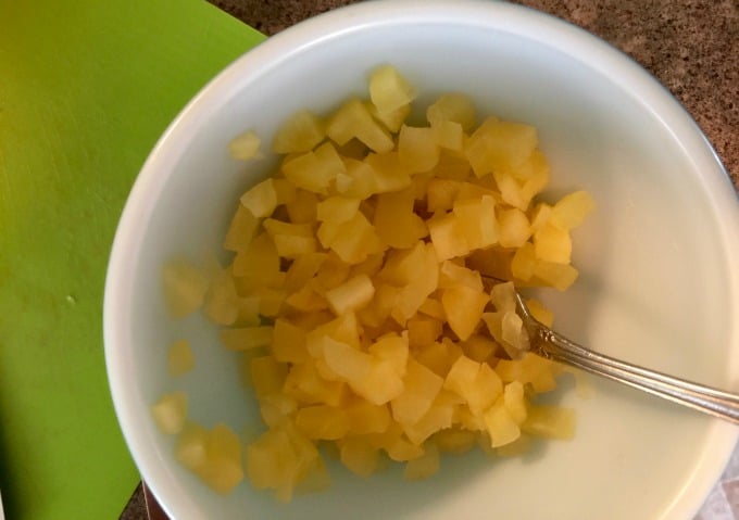 Peeled, chopped apples in white bowl.