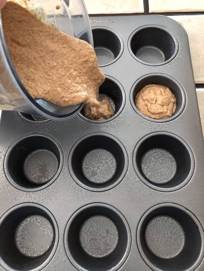 Filling muffin tin from batter in blender.