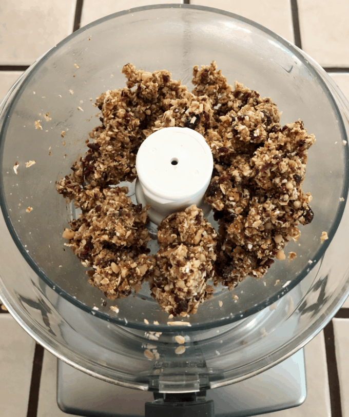 Crumbled oats, dried cranberries, dates and walnuts in food processor.