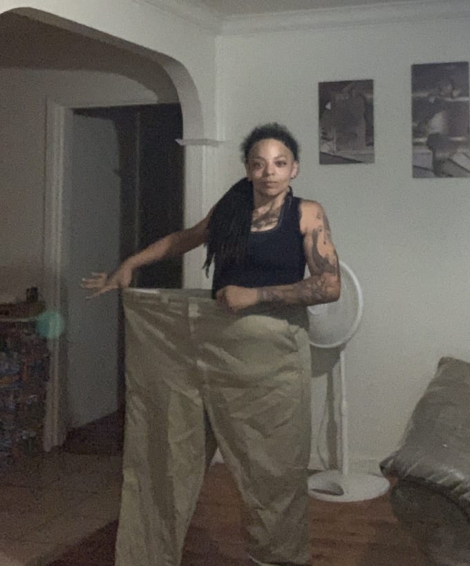 Denice standing in one leg of pants she used to wear.