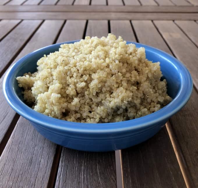 Instantpot quinoa in blue bowl on wood table.