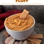 Pumpkin mousse fluff sprinkled with cinnamon in white bowl with apple slices and graham crackers for dipping.