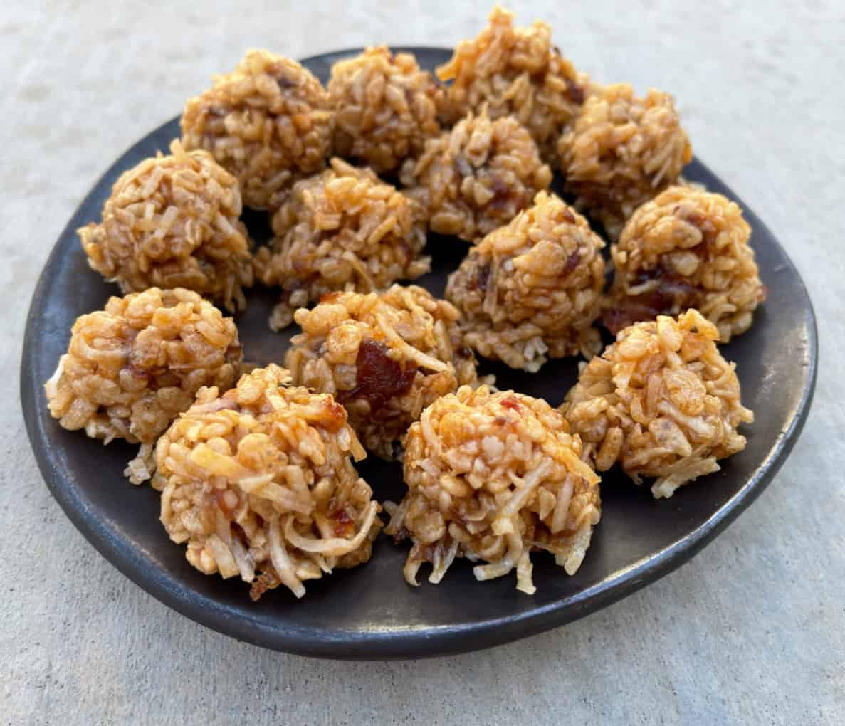 No Bake Rice Krispies Date Balls on brown serving platter.