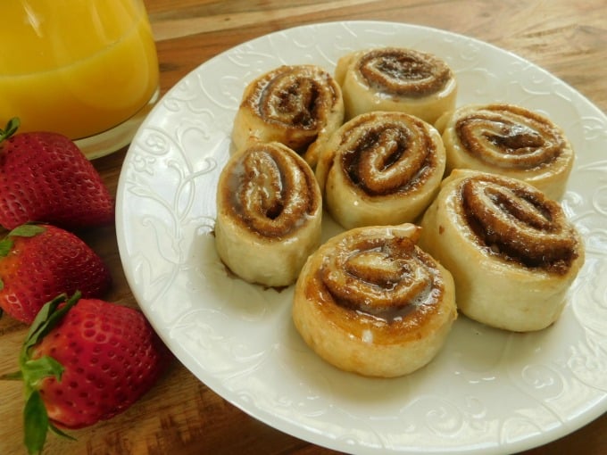 Cinnamon rolls made with 2-ingredient dough on white plate.