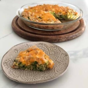 pottery plate with wedge of chicken broccoli impossible pie, pyrex pie plate with the remaining pie behind