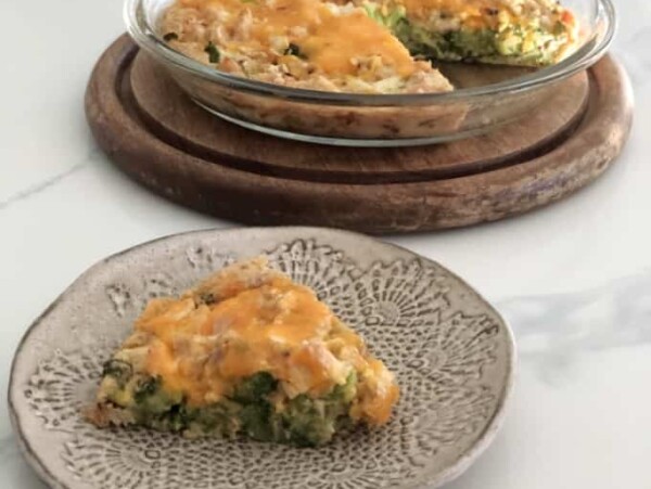 pottery plate with wedge of chicken broccoli impossible pie, pyrex pie plate with the remaining pie behind
