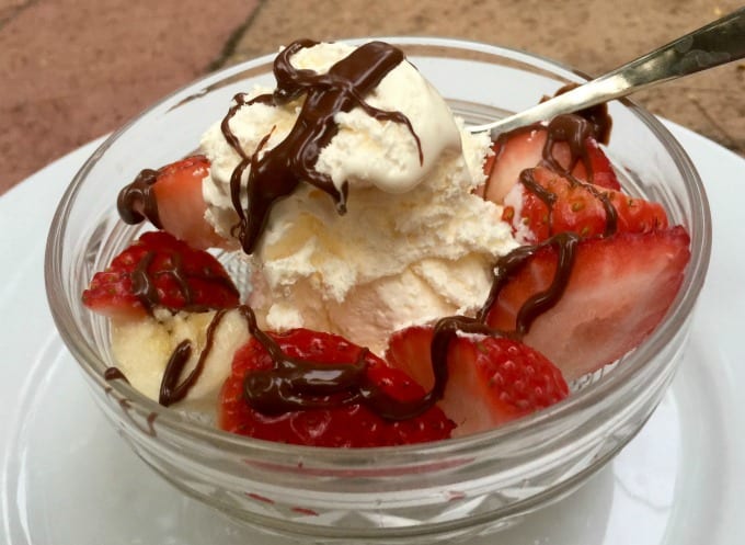 Frozen Cool Whip Banan Split with sliced strawberries and chocolate sauce drizzle.