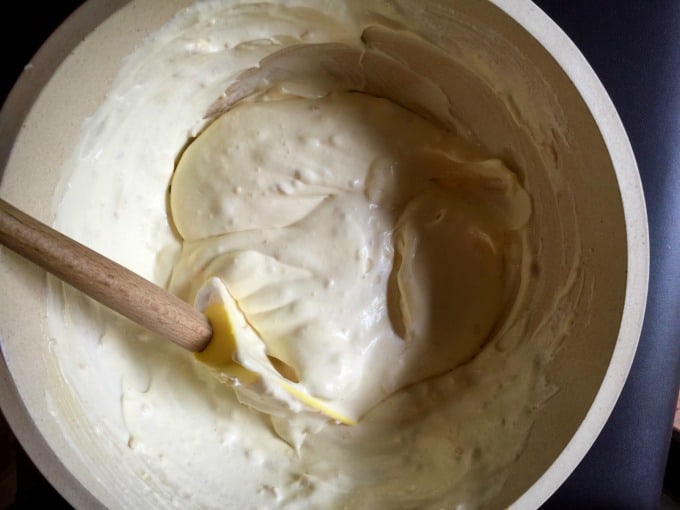 Mixing together no-bake pie filling in bowl with wooden spoon.