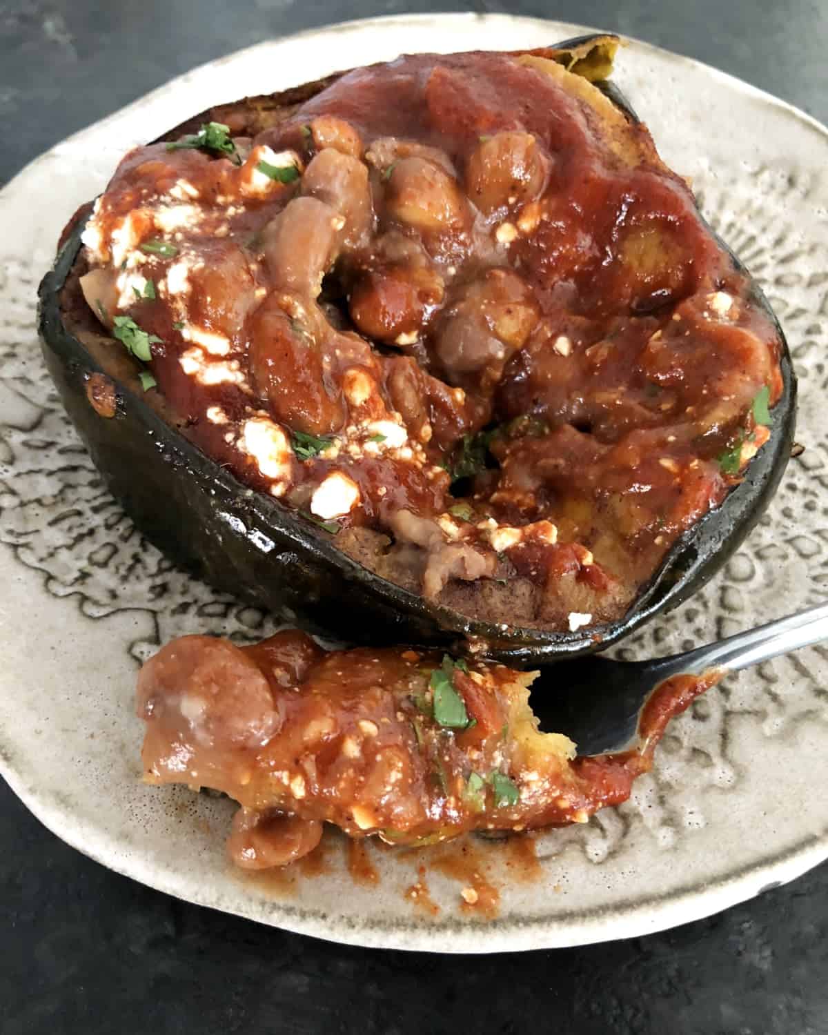 Oven-roasted acorn squash with red chili sauce and pinto beans