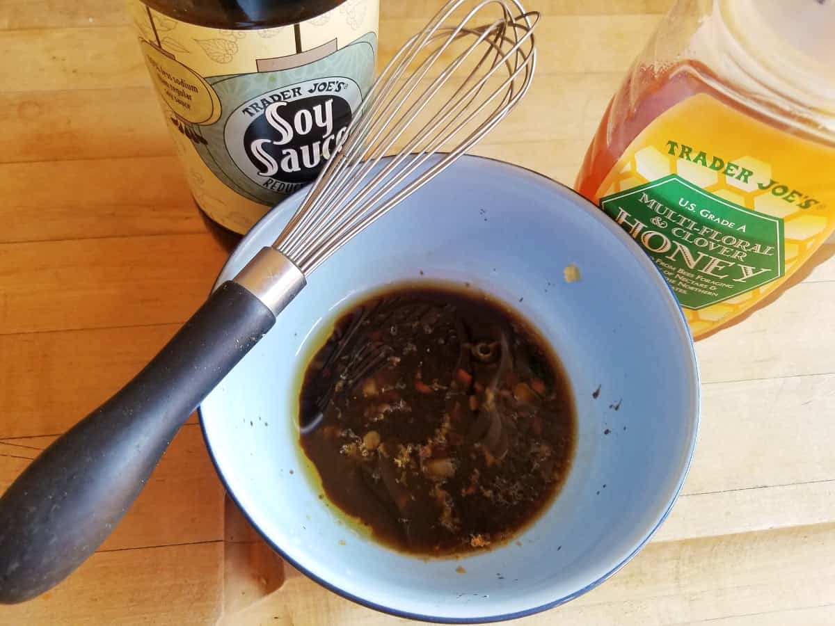 Soy sauce and honey mixture in small bowl with whisk.