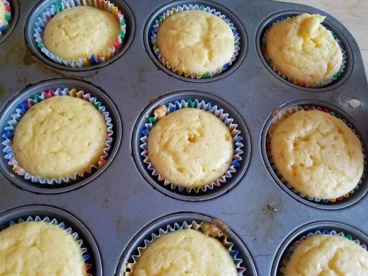 Fresh baked 7-Up Cake Mix Cupcakes in muffin tin.