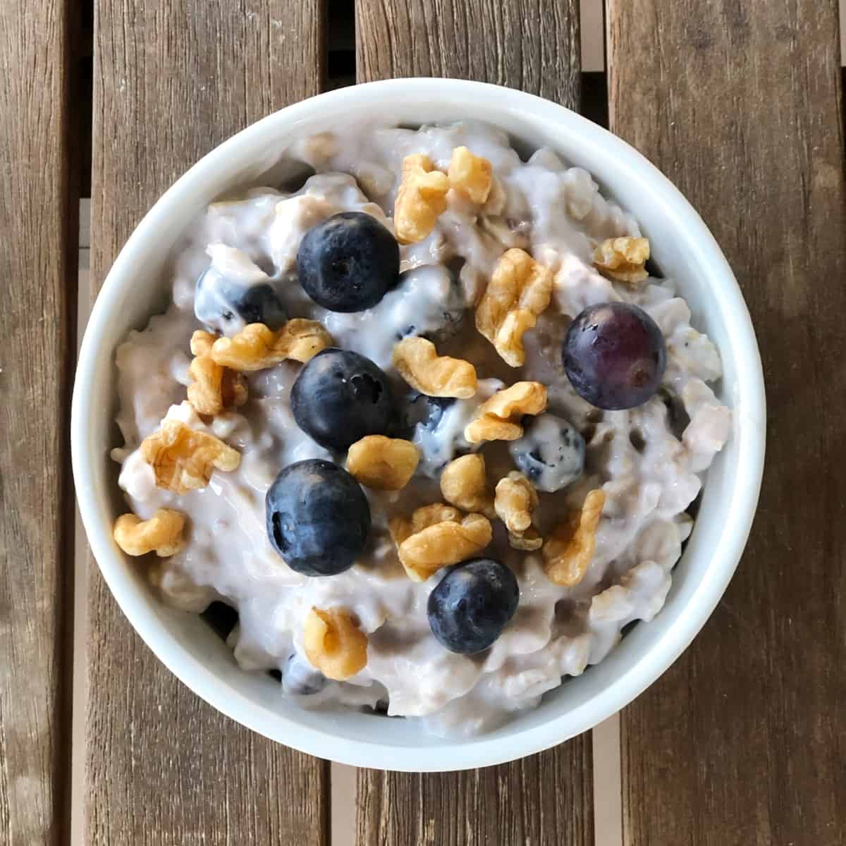 Blueberry maple overnight oats topped with toasted walnuts and fresh blueberries from above.