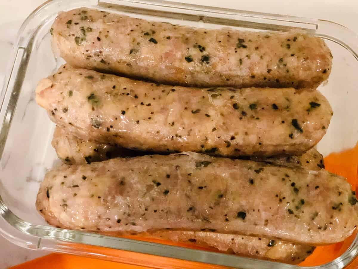 Chicken sausages in glass container.