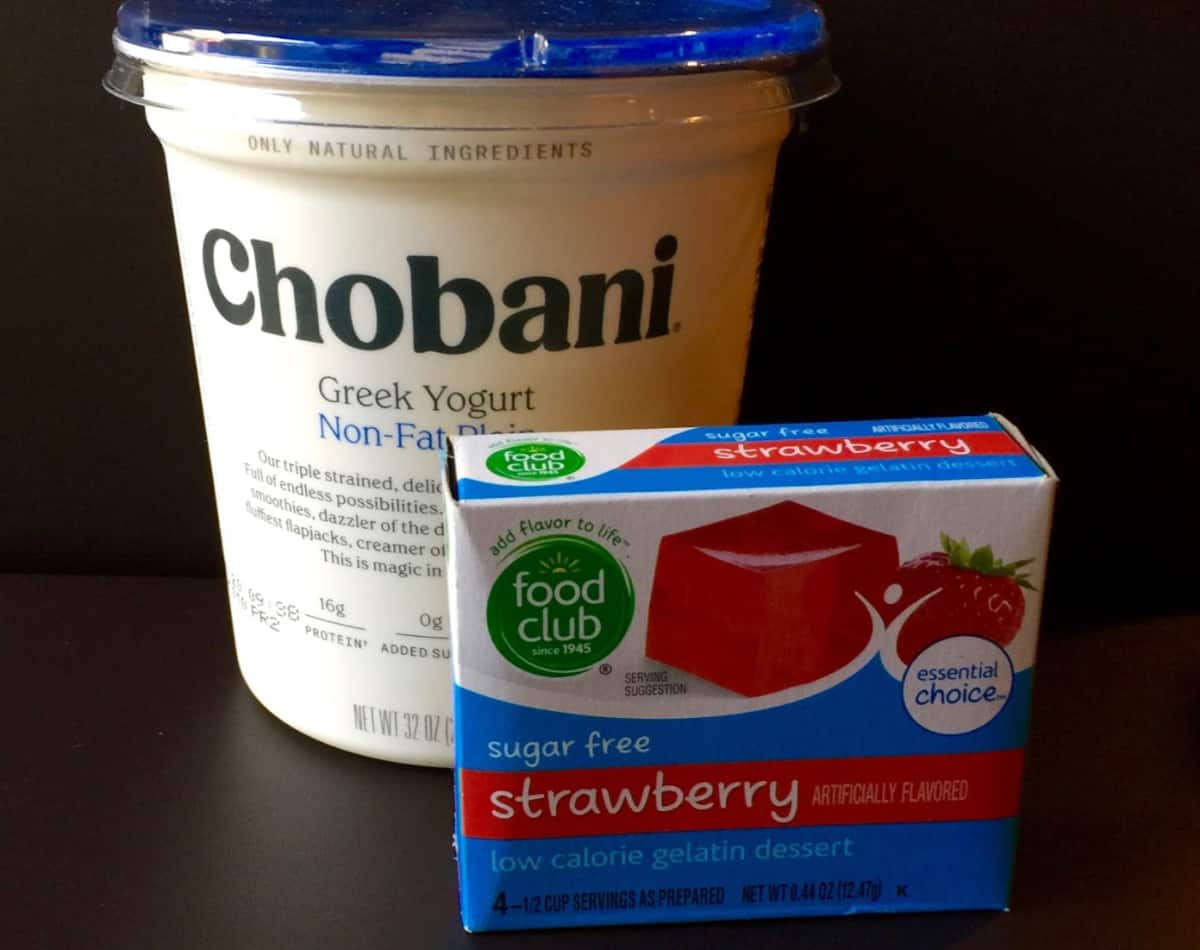 Container of Chobani Greek non-fat plain yogurt with box of sugar-free strawberry gelatin.