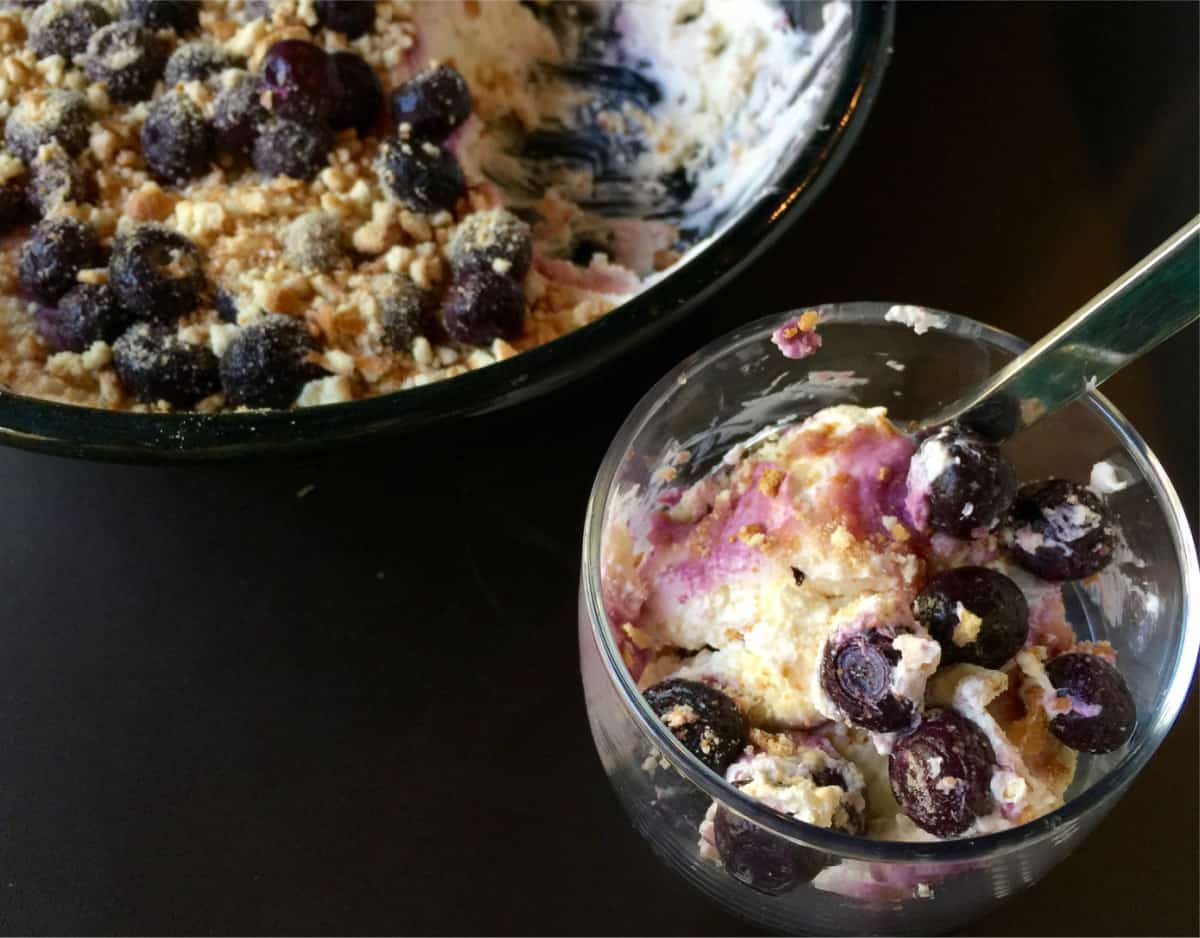 Spoonable Blueberry Cheesecake Dessert in small glass with a spoon.