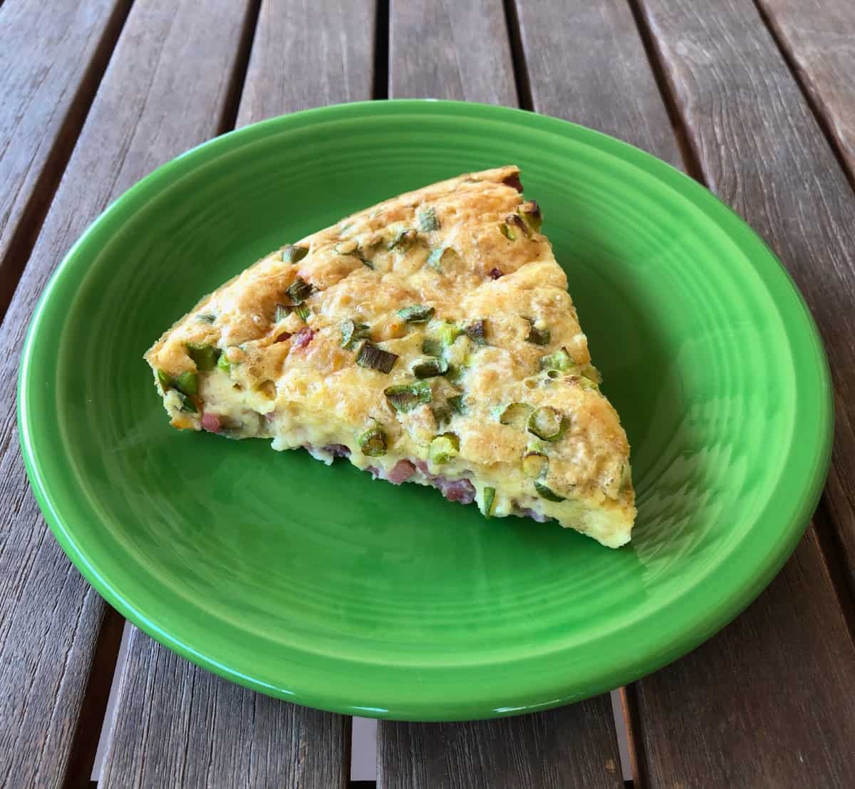Impossible Ham & Swiss Pie wedge on green plate.