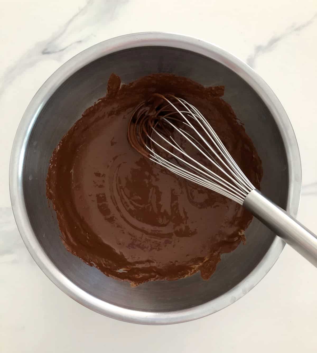 Whisking cocoa powder and lite coconut milk in mixing bowl.
