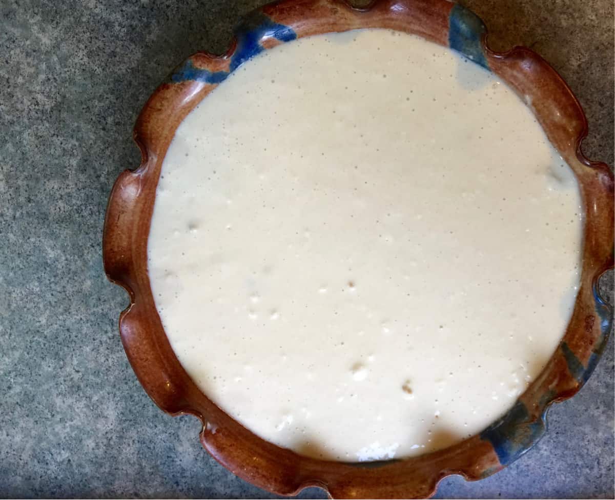 Unbaked homemade chicken pot pie in pretty ceramic pie dish.