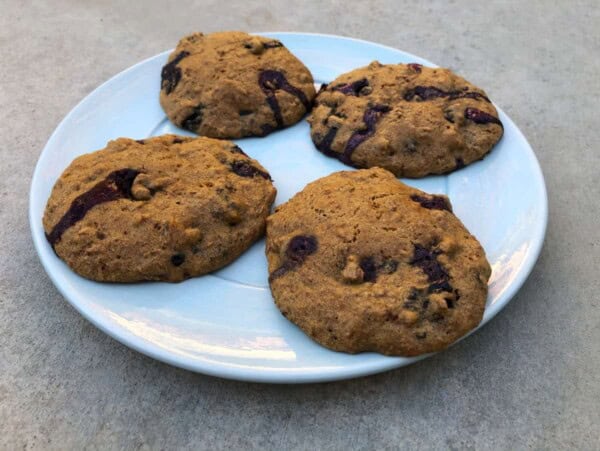 4 blueberry bran muffin tops on round white plate