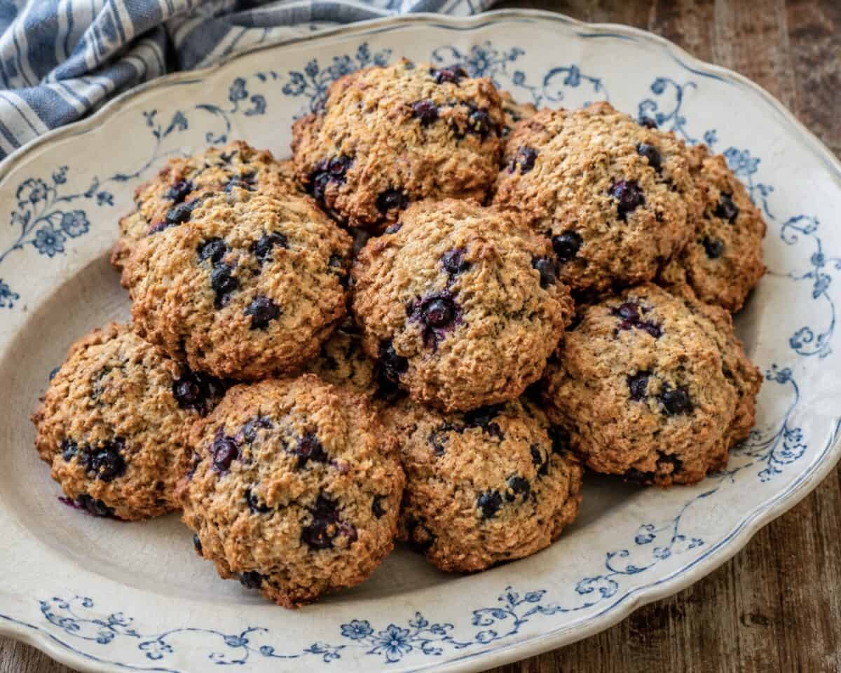 Homemade blueberry bran muffin tops on a vintage serving platter.