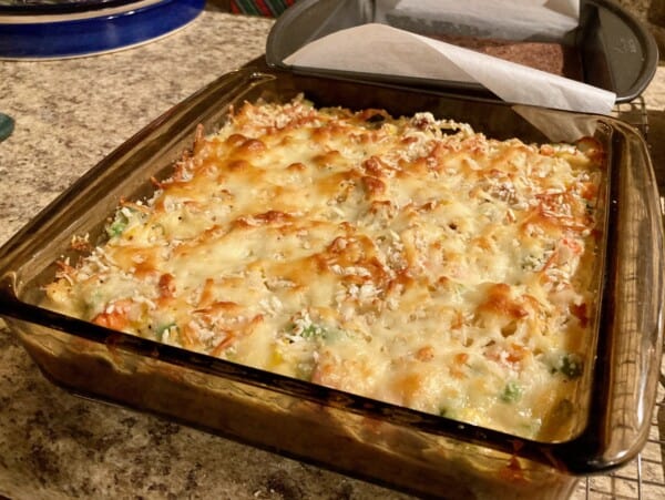 baked chicken noodle casserole in dark pyrex dish ready to enjoy