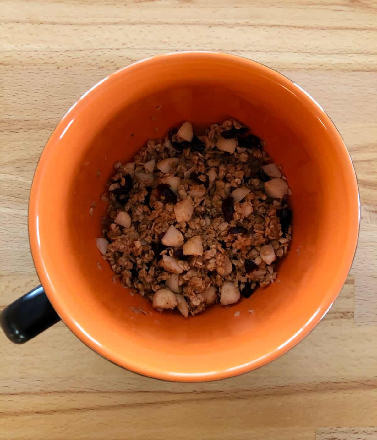 Macadamia Nut Microwave Granola in orange mug from above.