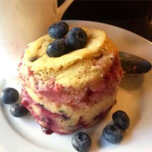 Microwave Mug Kodiak Protein Pancake on White Plate with White Mug in Background