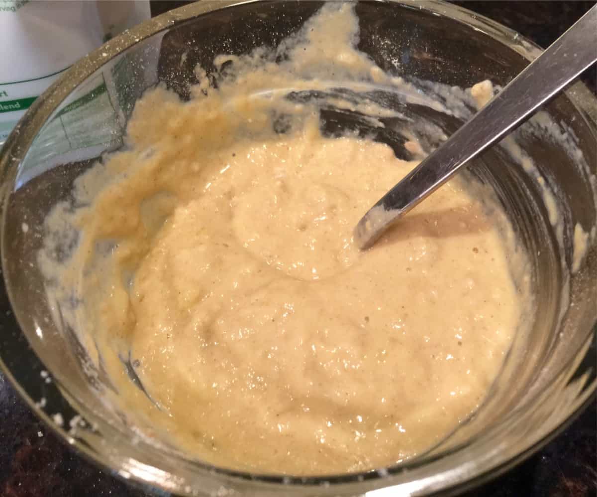 Mixing pancake batter in small glass bowl.