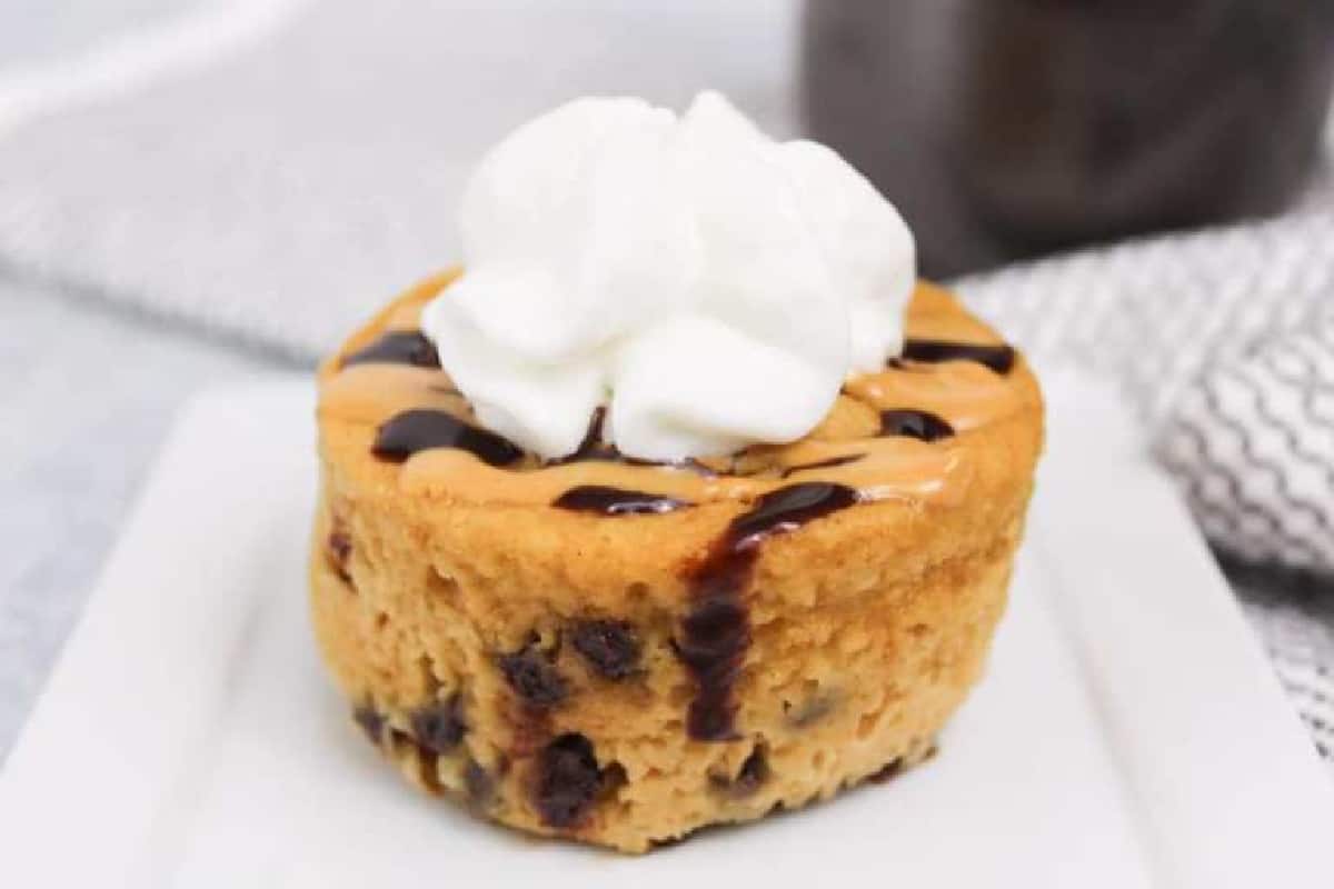 Single serving peanut butter mug cake with whipped topping.