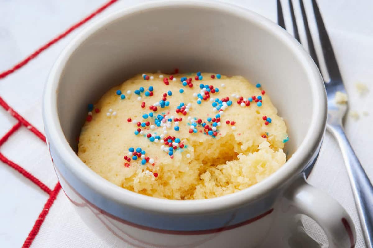 Microwave Vanilla Cake in mug with red, white and blue sprinkles.