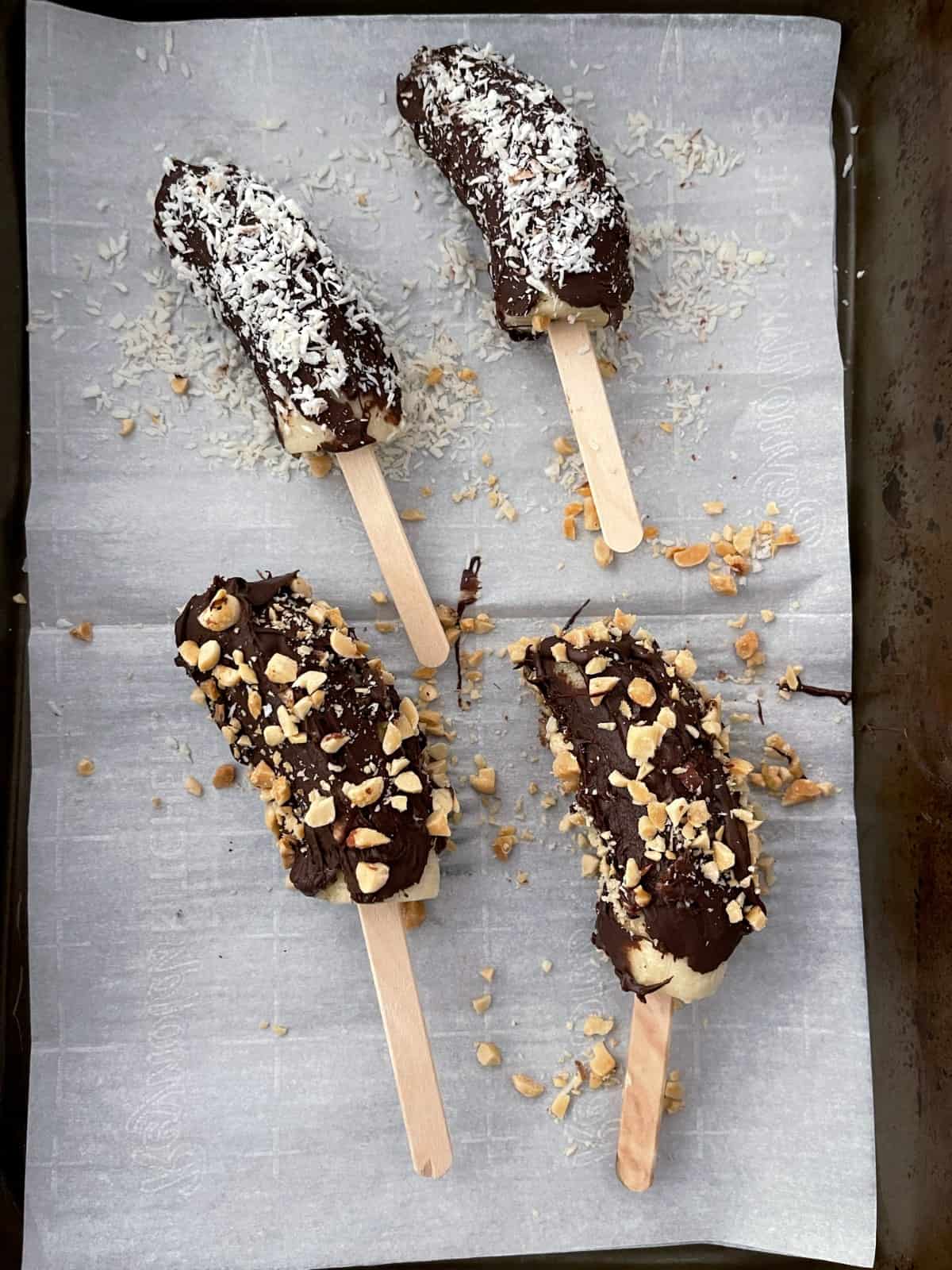 Chocolate dipped bananas coated with shredded coconut and chopped peanuts.