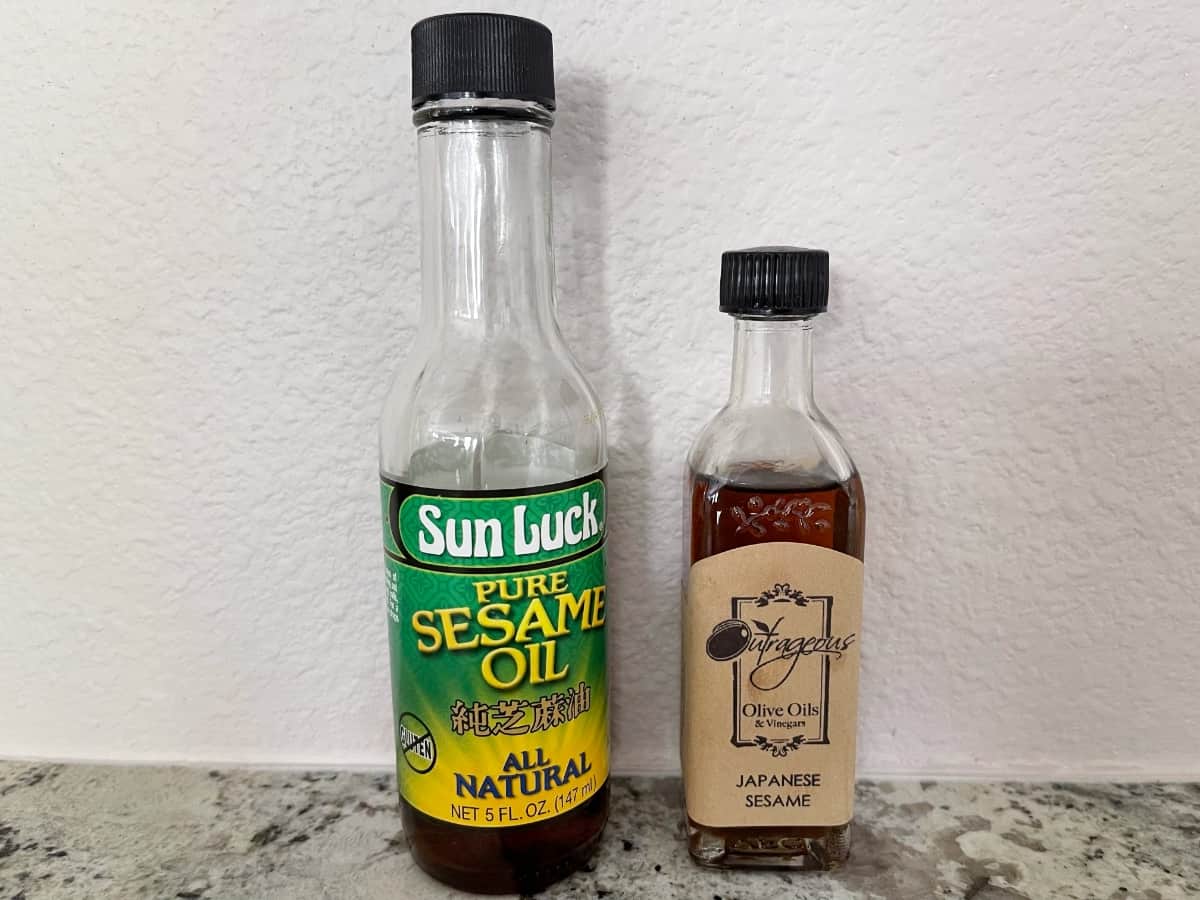 Two bottles sesame oil, one Sun Luck brand and the other from Outrageous Olive Oils.