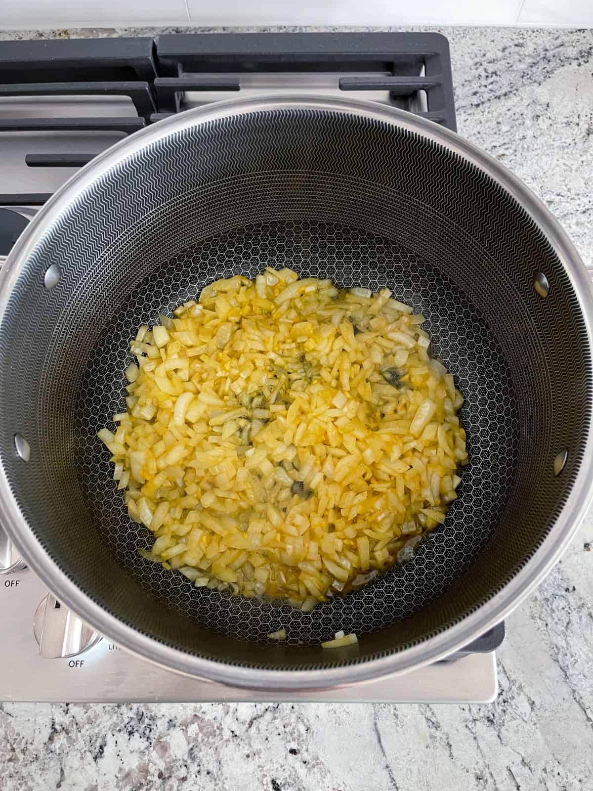Sauteeing onions, ginger and turmeric in coconut oil on stovetop