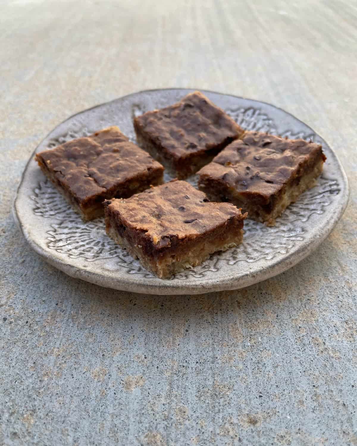 Four banana bread brownies on ceramic plate.