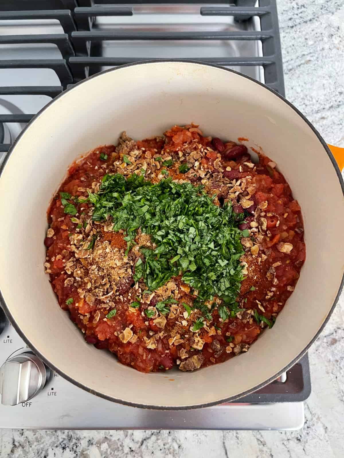 Uncooked meatless quorn chili in large sauce pan on stove top.