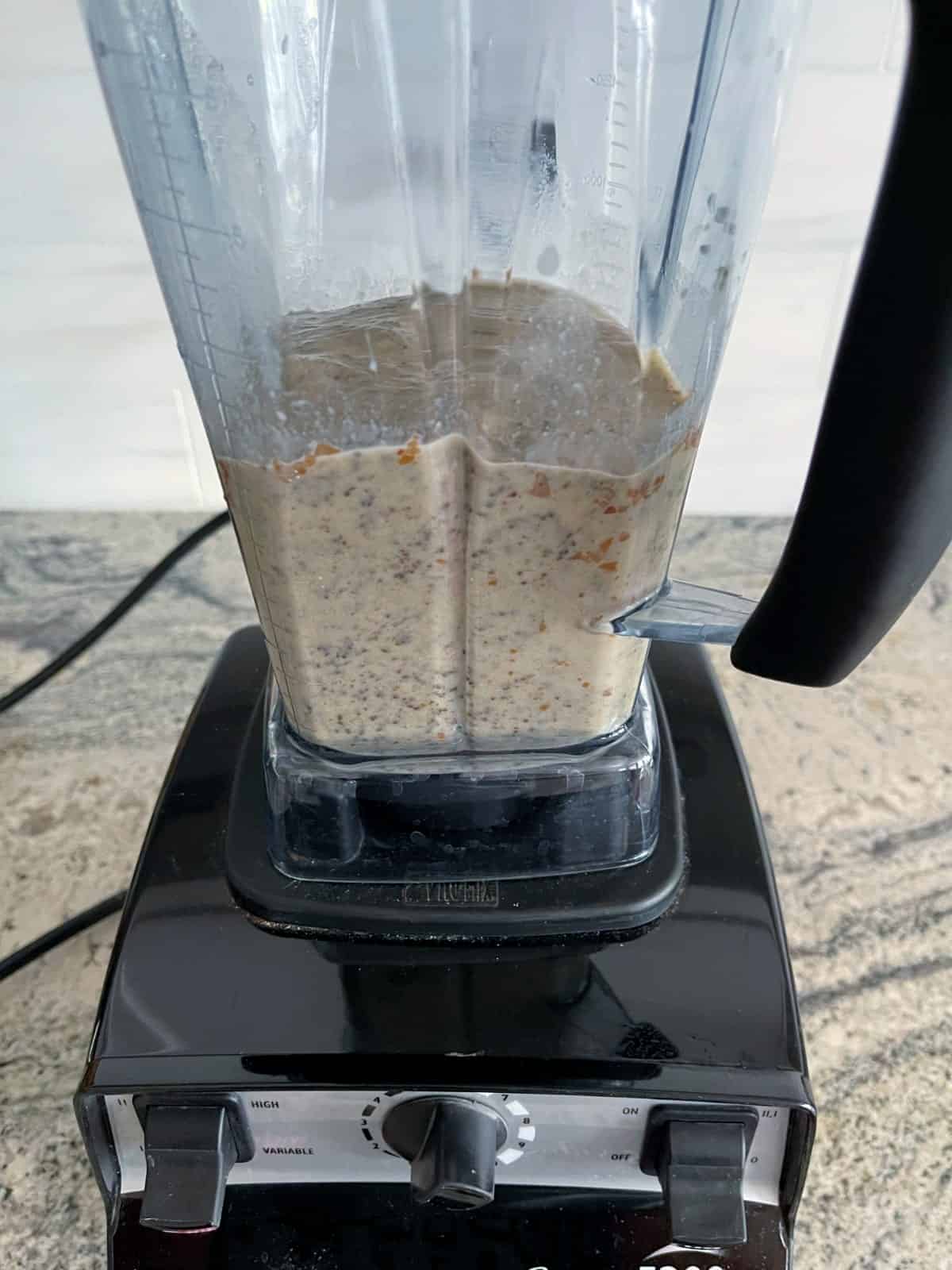 Blended almond milk, chia seeds and dates in Vitamix blender.