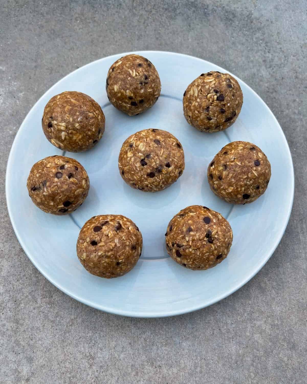Kodiak no-bake oatmeal chocolate chip protein balls in blue plate from above.