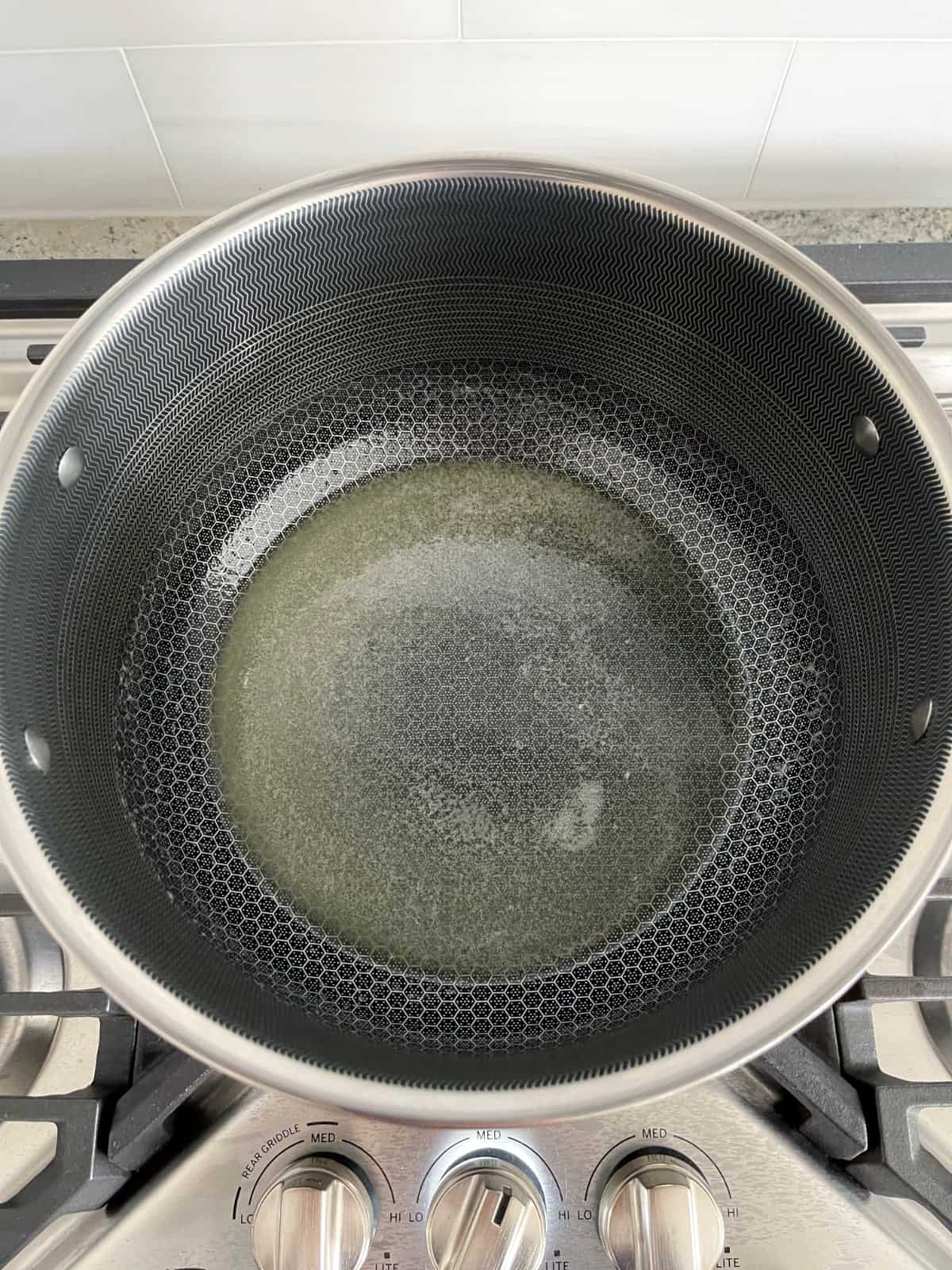 Melted butter in large saucepan on stovetop.