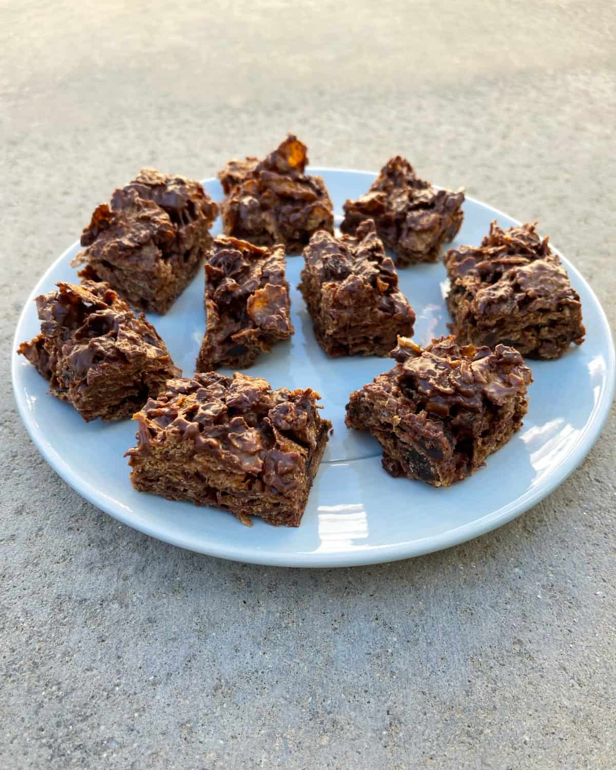 No-bake chocolate raisin bran treats on light blue serving plate.