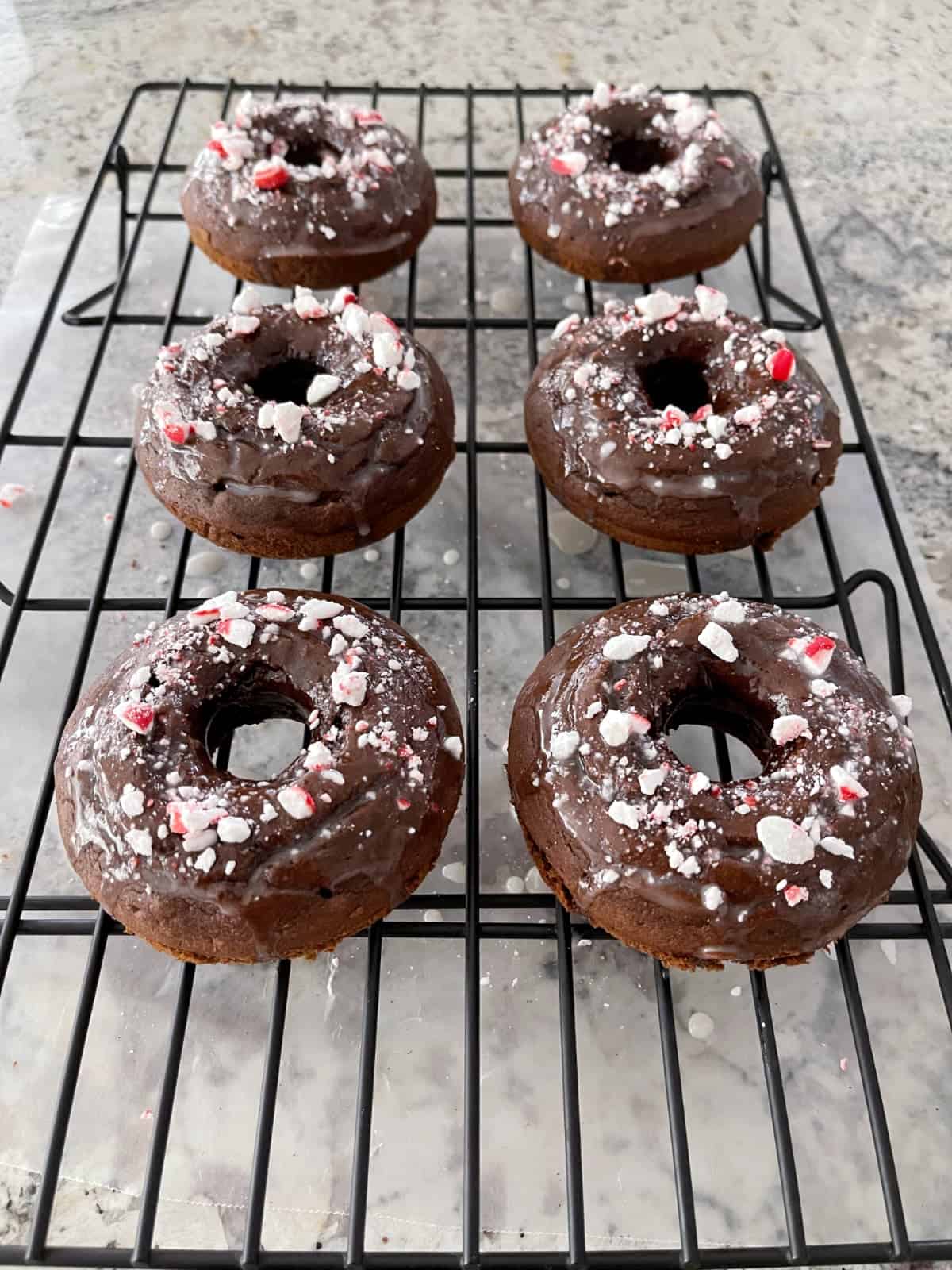 Mint chocolate glazed donuts on wire rack