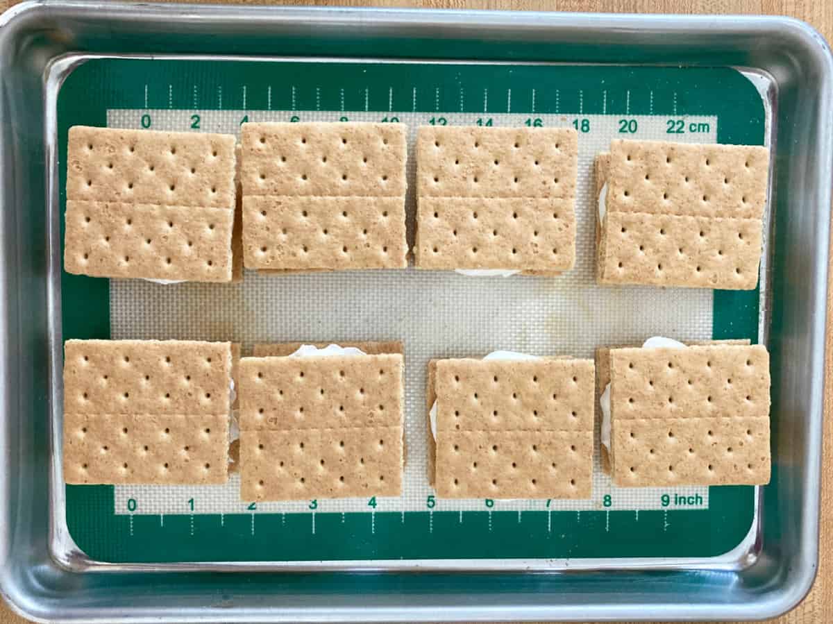 Graham cracker cool whip sandwiches on baking sheet from above.