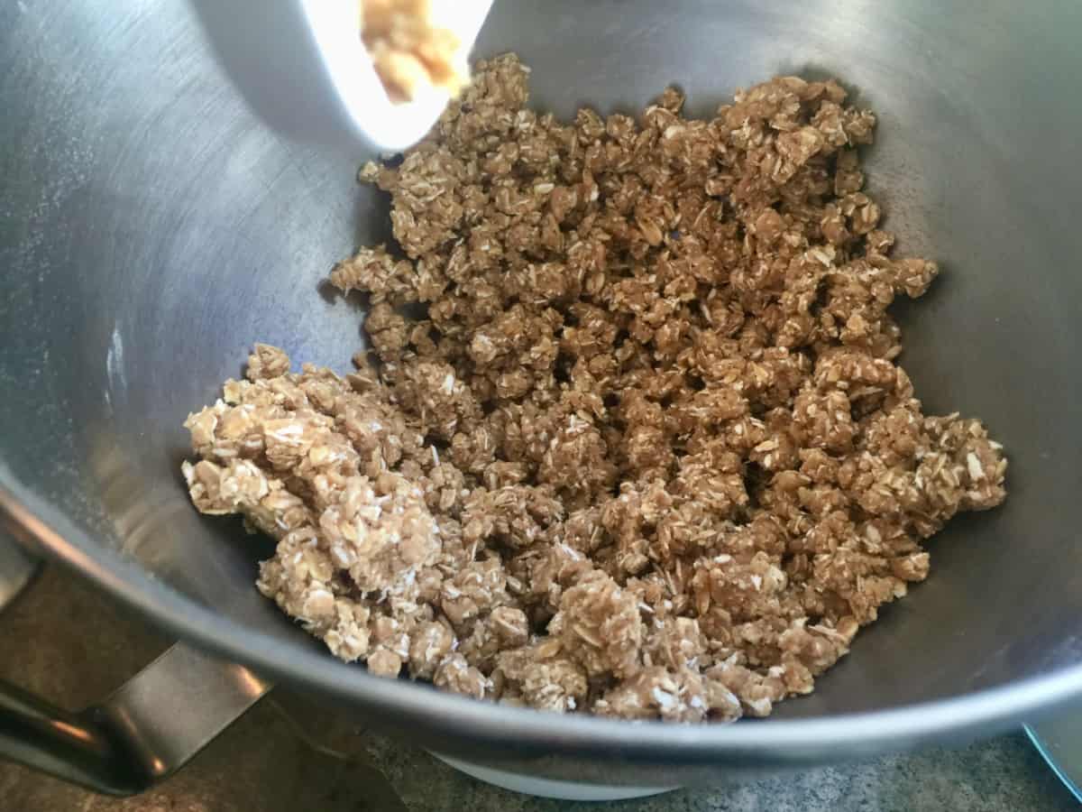 Mixing oat crust in electric stand mixer.