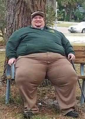 Jim H. sitting on a bench, before losing 350 pounds.