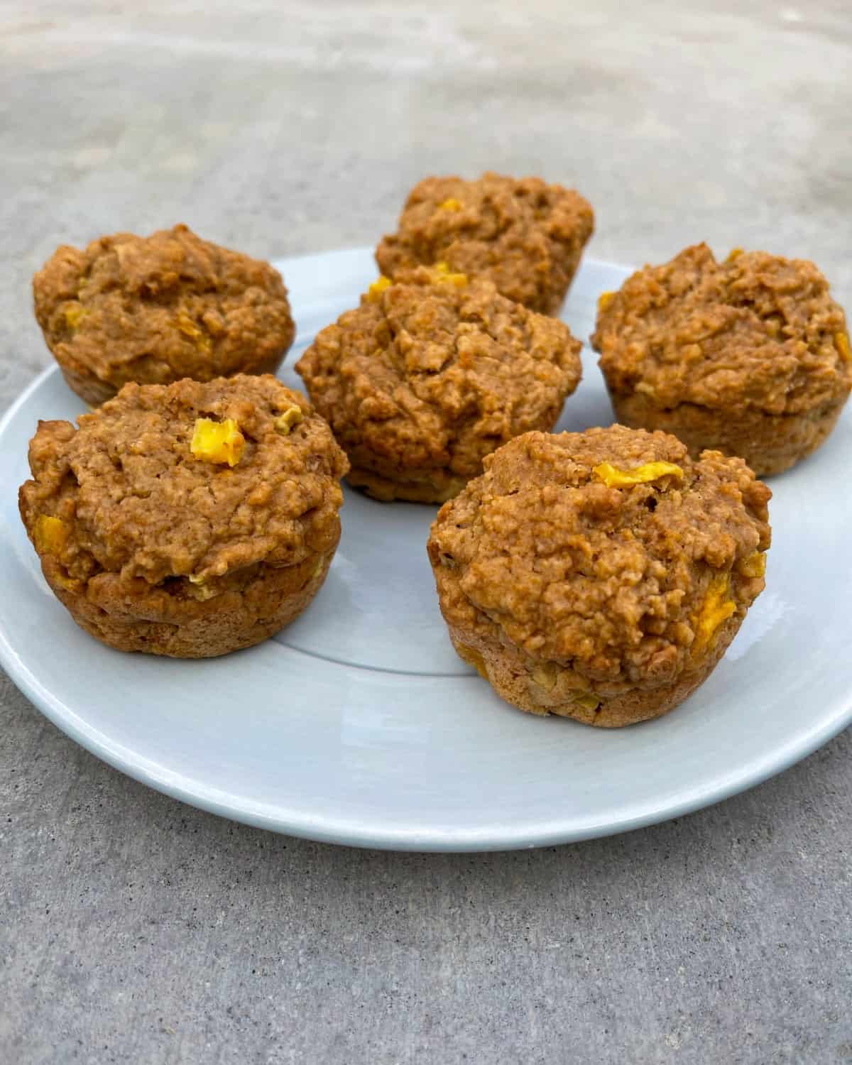 Fiber one mango muffins on blue serving plate.
